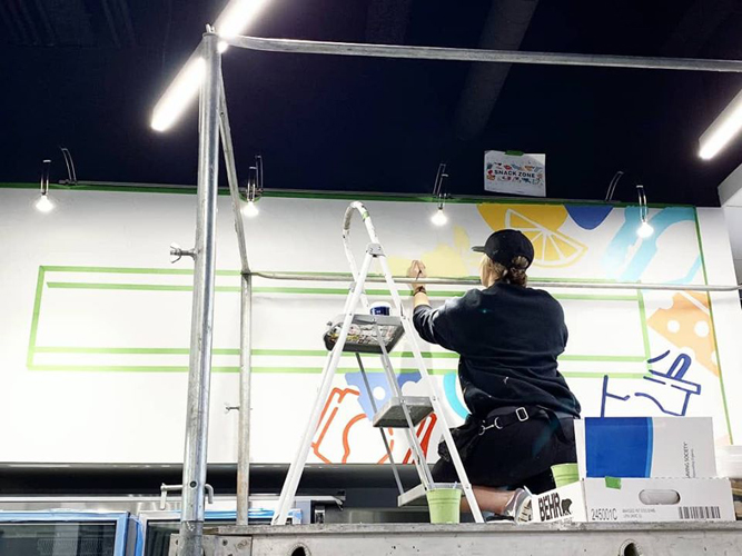 Mural installation process, custom graffiti art.